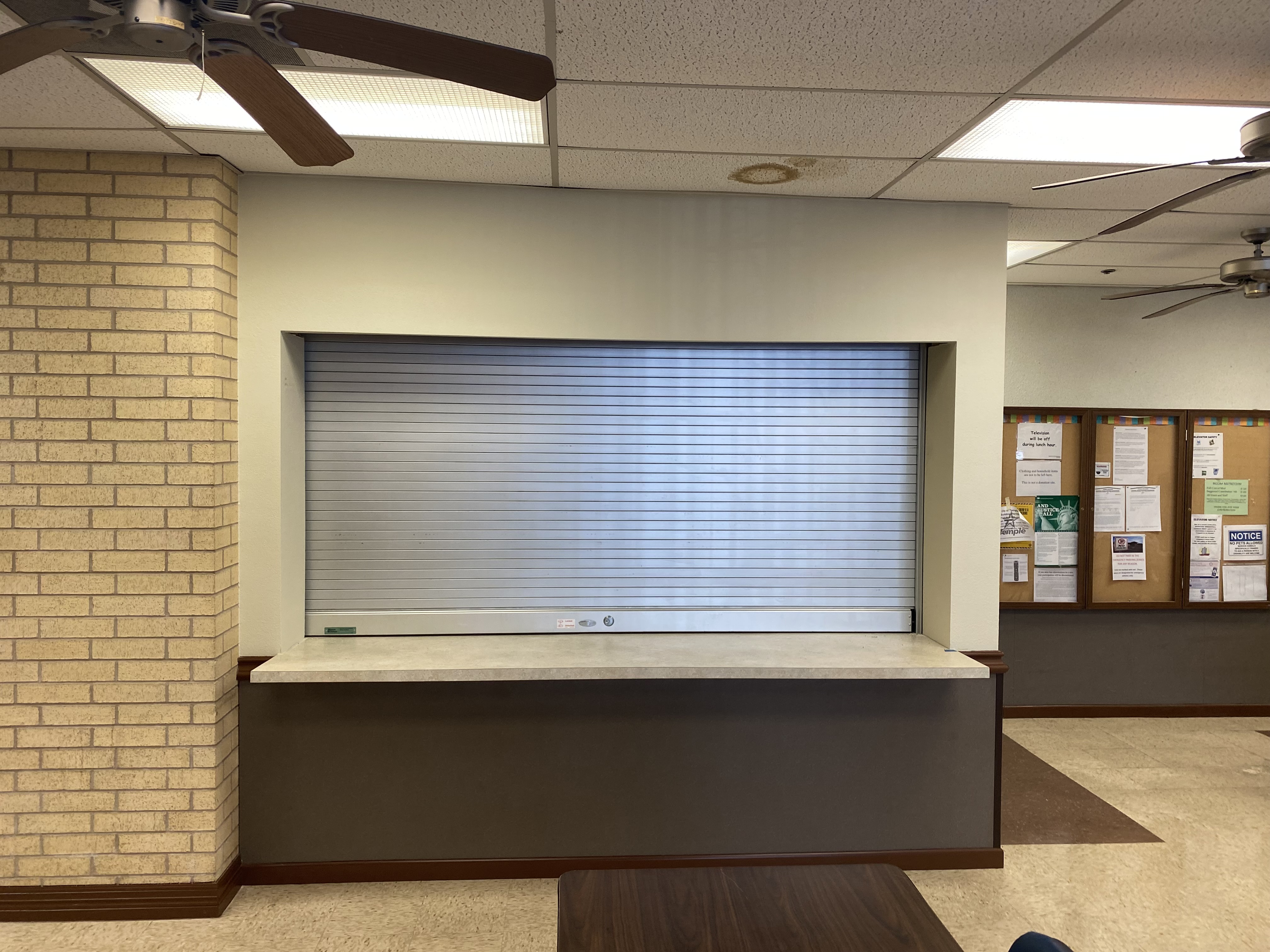 Commercial roll-up counter door installed at interior service window in office building in Temple, TX